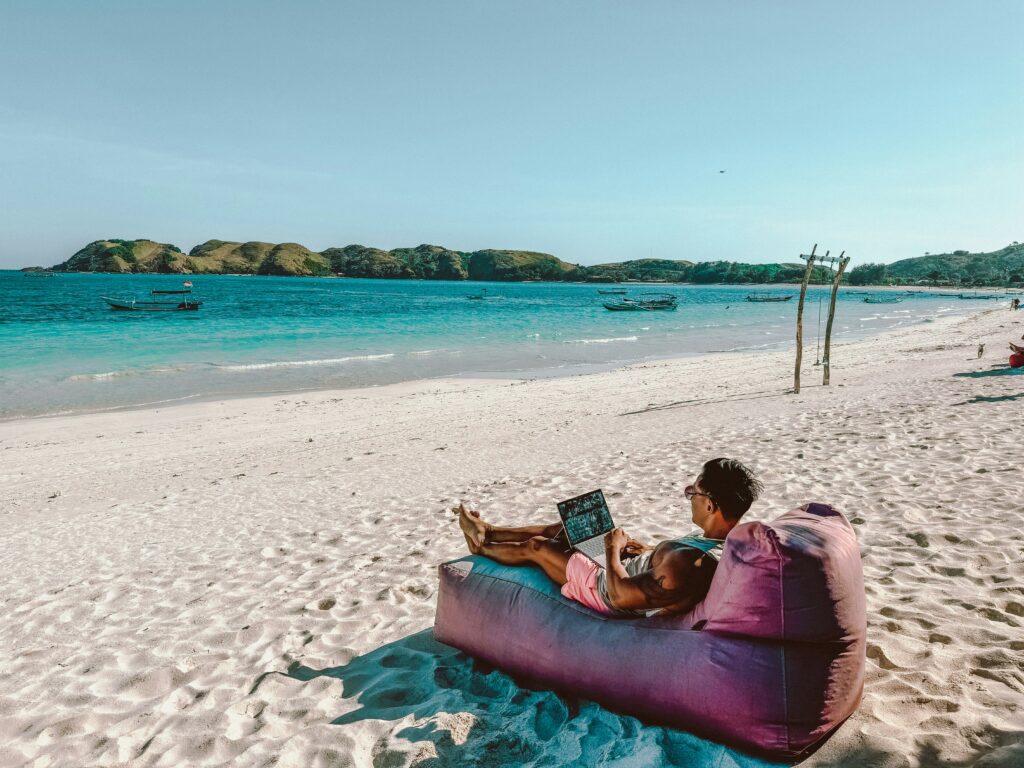 digital nomad working from a beach